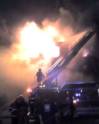 Fire fighters around the truck plan to stop the fire.